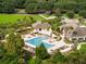 A sparkling community pool with a splash fountain surrounded by mature landscaping and lounge seating at 1614 Live Oak Park, Seabrook Island, SC 29455