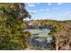Overhead view of maintained tennis courts surrounded by trees, adjacent to a residential area at 1614 Live Oak Park, Seabrook Island, SC 29455