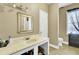 Bathroom showcasing a sink with marble countertop, decorative mirror, and a separate toilet area at 162 Wal Flo Ln, Moncks Corner, SC 29461