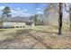 Exterior shot of the home and the surrounding large yard with mature trees at 162 Wal Flo Ln, Moncks Corner, SC 29461
