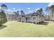Single-story home with a spacious green lawn, set in a serene, tree-lined neighborhood at 162 Wal Flo Ln, Moncks Corner, SC 29461