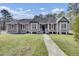 Inviting single-story home featuring a well-manicured lawn and a classic facade at 162 Wal Flo Ln, Moncks Corner, SC 29461
