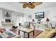 Bright living room featuring a ceiling fan, TV, and two sofas with hardwood flooring at 162 Wal Flo Ln, Moncks Corner, SC 29461