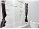 Compact shower-tub combination featuring white tiling and modern fixtures, perfect for efficient space utilization at 162 Wal Flo Ln, Moncks Corner, SC 29461