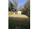 Fenced backyard with shed, grass, and surrounding trees at 1770 Skinner Ave, Charleston, SC 29407