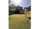 Backyard featuring a covered patio, shed, grassy area, and wooden fence at 1770 Skinner Ave, Charleston, SC 29407