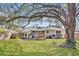Expansive backyard with a deck, patio, mature trees, and well-manicured lawn at 1950 Culver Ave, Charleston, SC 29407