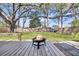 Inviting backyard with a wooden deck featuring a fire pit and a well-maintained lawn at 1950 Culver Ave, Charleston, SC 29407