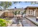 Cozy backyard featuring a dining table, deck, and a privacy fence with palm trees at 1950 Culver Ave, Charleston, SC 29407