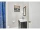Bathroom featuring a dark vanity, toilet, wall art, and blue patterned shower curtain at 1950 Culver Ave, Charleston, SC 29407