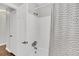 Bathroom showcasing a shower with patterned curtain and a door to storage or closet at 1950 Culver Ave, Charleston, SC 29407