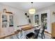 Dining room with wooden table and chairs, a hutch, and view of french doors at 1950 Culver Ave, Charleston, SC 29407