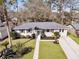 Inviting home with beautiful landscaping, mature trees, and a freshly manicured front lawn at 1950 Culver Ave, Charleston, SC 29407