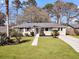Charming single-story home with lush green lawn and mature trees in a desirable neighborhood at 1950 Culver Ave, Charleston, SC 29407