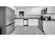 Modern kitchen with stainless steel appliances, white cabinets, and gray backsplash and countertops at 1950 Culver Ave, Charleston, SC 29407