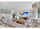 Bright living room with stylish furniture, a TV, hardwood floors, and an open view to kitchen at 1950 Culver Ave, Charleston, SC 29407