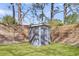 Backyard shed surrounded by a well-maintained lawn and a wooden fence at 1950 Culver Ave, Charleston, SC 29407