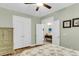 Serene bedroom featuring a ceiling fan, closet and hall entries and light green walls and contrasting white trim at 2012 Barn Swallow Rd, Summerville, SC 29483
