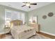 Cozy bedroom with a ceiling fan, a comfortable queen-size bed, soft lighting, and serene decor at 2012 Barn Swallow Rd, Summerville, SC 29483