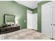 A calming green bedroom featuring a large dresser with a mirror, next to the walk-in closet entrance at 2012 Barn Swallow Rd, Summerville, SC 29483