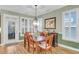 Light-filled dining room with a rustic chandelier, plantation shutters and views to the living room at 2012 Barn Swallow Rd, Summerville, SC 29483