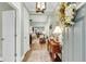 Inviting entryway with wood floors, decorative console table, and a view into the living and dining areas at 2012 Barn Swallow Rd, Summerville, SC 29483