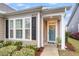 Beautiful home showcasing the front door with a decorative wreath, lush landscaping, and classic architectural details at 2012 Barn Swallow Rd, Summerville, SC 29483