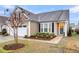 Charming home with a manicured front yard featuring mature landscaping, a two-car garage, and a welcoming entrance at 2012 Barn Swallow Rd, Summerville, SC 29483