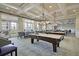 Spacious game room with pool tables, comfortable seating, and elegant lighting fixtures at 2012 Barn Swallow Rd, Summerville, SC 29483