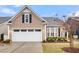 Charming home with a manicured front yard featuring mature landscaping and a two-car garage with a private entry at 2012 Barn Swallow Rd, Summerville, SC 29483