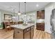 Open-concept kitchen island with granite countertops connects to dining room and living room at 2012 Barn Swallow Rd, Summerville, SC 29483