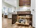 A modern kitchen featuring a wet bar with an under-counter beverage center and pull-out shelves for optimized storage at 2012 Barn Swallow Rd, Summerville, SC 29483