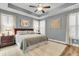 A large main bedroom suite boasting a tray ceiling, plantation shutters, and a stylish accent painting at 2012 Barn Swallow Rd, Summerville, SC 29483