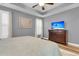 Spacious main bedroom suite features a tray ceiling, hardwood flooring, plantation shutters, and a TV at 2012 Barn Swallow Rd, Summerville, SC 29483