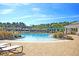 Large community pool with lounge chairs and umbrellas on a sunny day at 2012 Barn Swallow Rd, Summerville, SC 29483