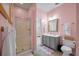 Pink bathroom featuring a glass shower, gray vanity, and a doorway to a Bedroom at 204 Branch Creek Trl, Summerville, SC 29483