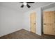 This bedroom features modern flooring, a ceiling fan, and beautiful wooden doors at 2124 Booker St, Charleston, SC 29405