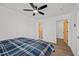 This bedroom features modern flooring, a ceiling fan, and beautiful wooden doors at 2124 Booker St, Charleston, SC 29405