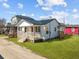 Charming cottage-style home with a covered front porch and a well-maintained lawn at 2124 Booker St, Charleston, SC 29405