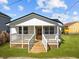 Charming single story home with front porch, white picket fence, and manicured lawn at 2124 Booker St, Charleston, SC 29405