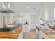 This kitchen features white cabinets, butcher block countertops, and stainless steel appliances at 2124 Booker St, Charleston, SC 29405