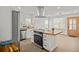 This kitchen features white cabinets, stainless steel appliances, and an island with a wooden countertop at 2124 Booker St, Charleston, SC 29405