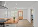 This living room features modern flooring and a beautiful wooden door to the bedroom at 2124 Booker St, Charleston, SC 29405