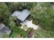 Expansive aerial view of home with a metal roof surrounded by mature trees and a lush landscape at 219 Forest Trl, Isle of Palms, SC 29451
