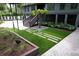 Backyard landscaped with pavers, artificial grass, and a swing-set providing outdoor enjoyment and visual appeal at 219 Forest Trl, Isle of Palms, SC 29451
