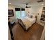 Cozy bedroom with a comfortable bed, natural light, a bookshelf, and stylish decor creates a welcoming retreat at 219 Forest Trl, Isle of Palms, SC 29451