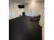 Home gym in basement featuring rubber flooring, TV, weight bench, and closed storage at 219 Forest Trl, Isle of Palms, SC 29451