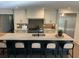Spacious eat-in kitchen with large center island, modern appliances, light cabinets, and stylish backsplash at 219 Forest Trl, Isle of Palms, SC 29451
