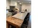 Kitchen with large center island with bar seating, stainless appliances, unique butcher block counter, and ample storage at 219 Forest Trl, Isle of Palms, SC 29451