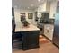 Well-lit kitchen features a large island with seating, stainless steel appliances, and a walk-in pantry at 219 Forest Trl, Isle of Palms, SC 29451